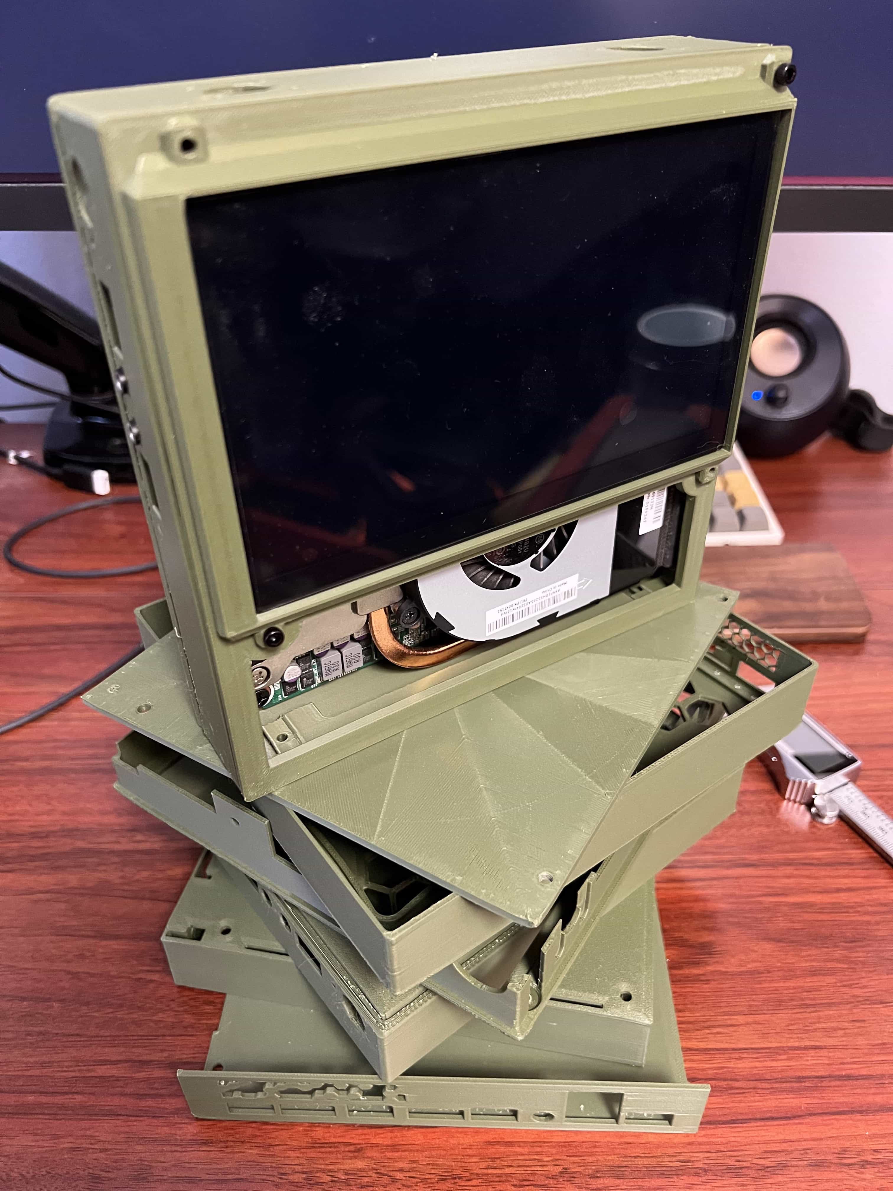 Stack of 3D printed prototype case parts during the design process